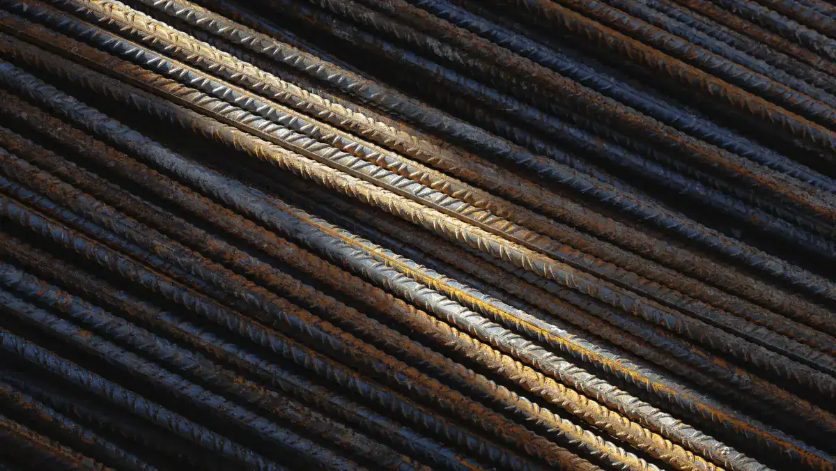 A close view of deformed reinforcing bar, the steel tied into a grid to hold cracks tight in a slab that carries vehicle loads.