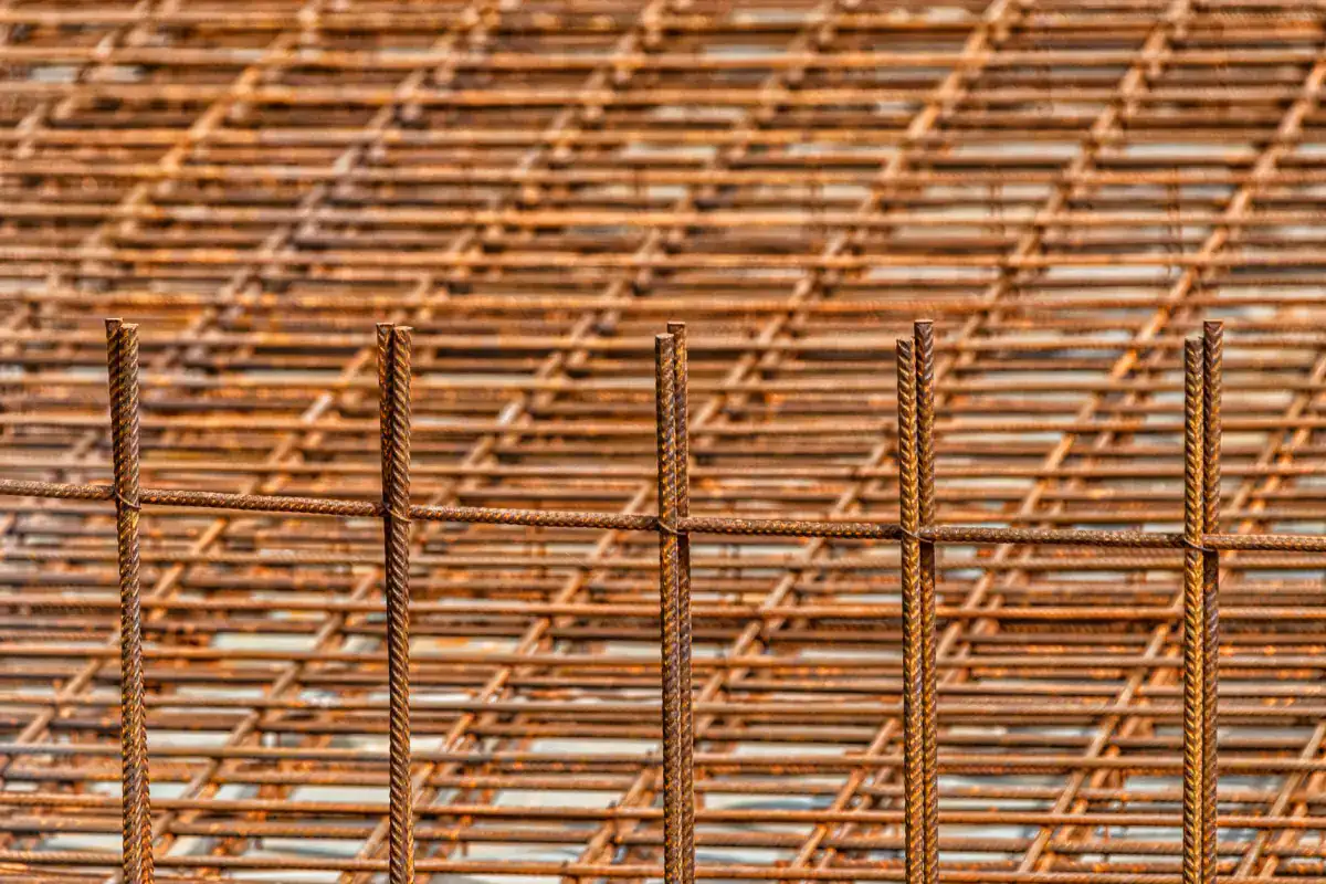 Stacked sheets of welded reinforcing mesh, the grid material used to control cracking across a concrete slab.