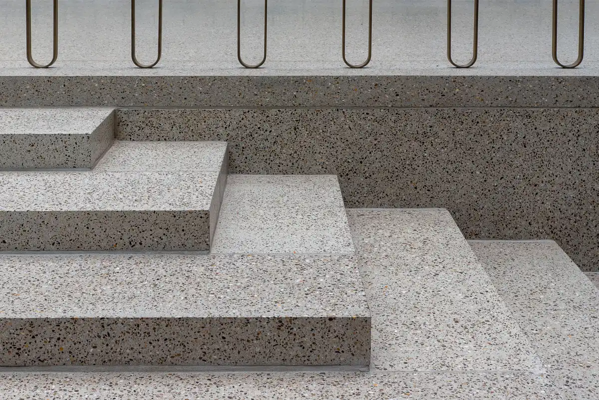 Concrete steps and landings finished with an exposed aggregate surface, showing the crisp nosings and the contrast between the tread and riser finishes.